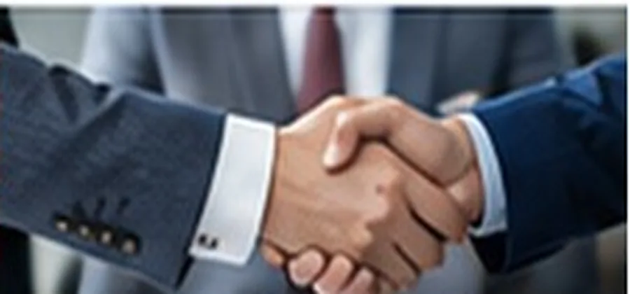 Business professionals shaking hands over a contract